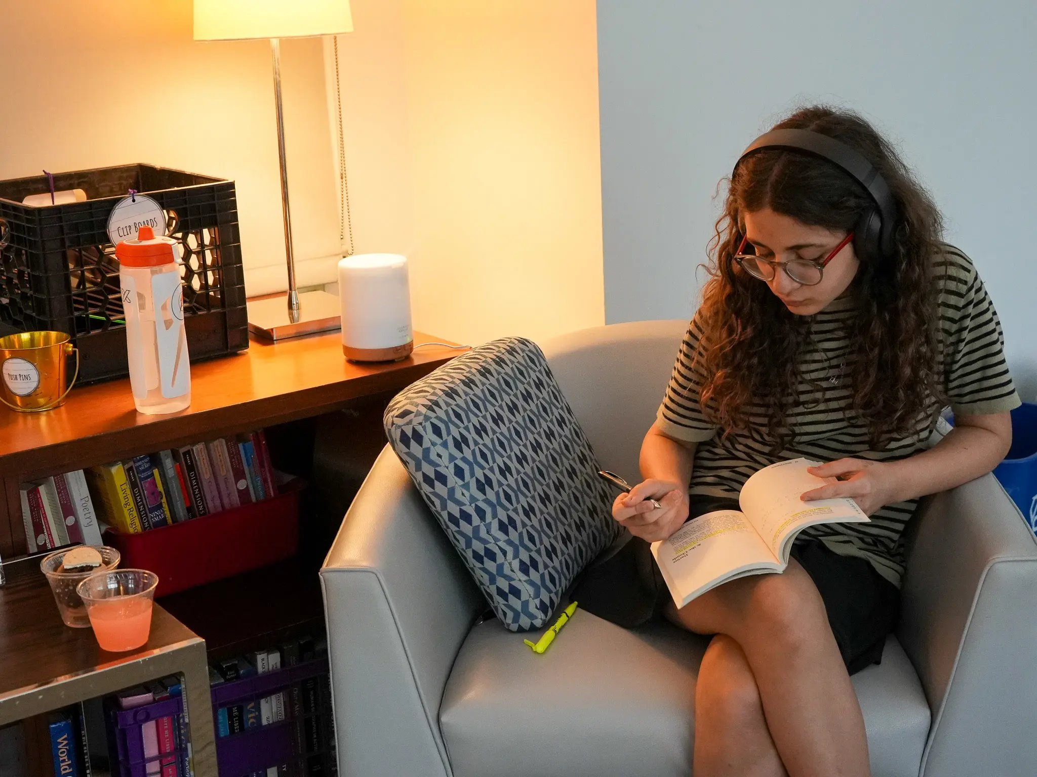NCS girl sitting in chair and taking notes in book