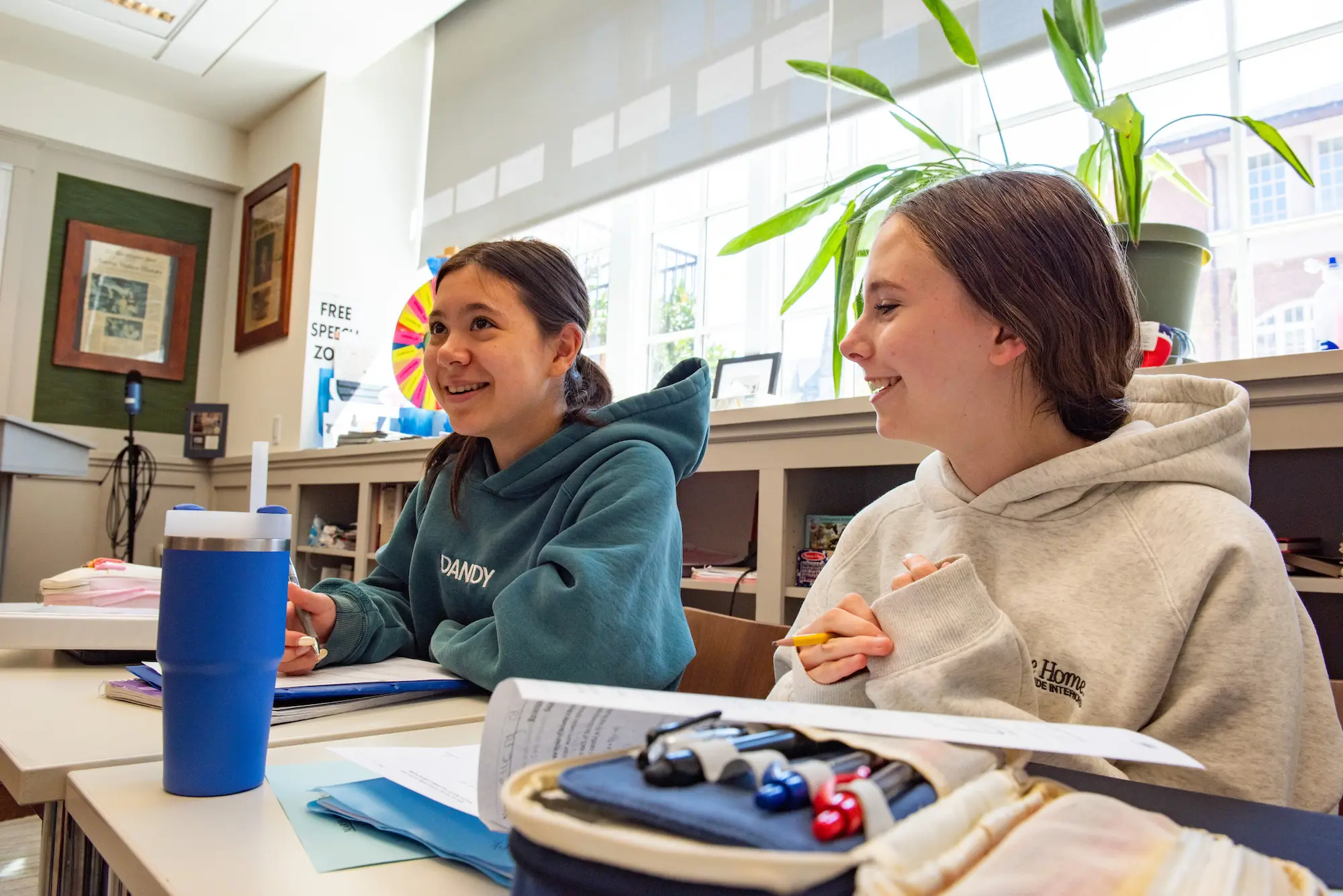 Two NCS girls sitting at their desks in class