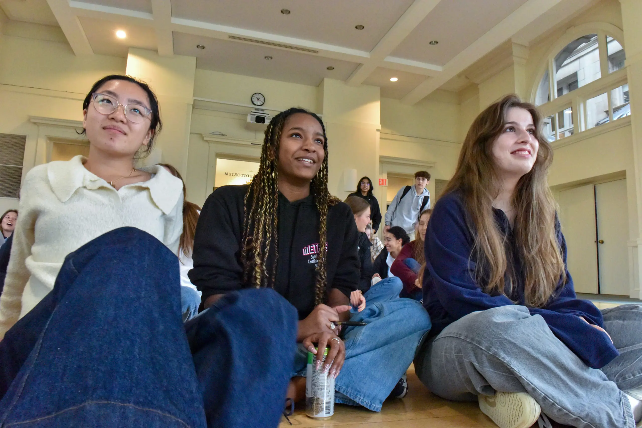 Three NCS girls sitting on the floor
