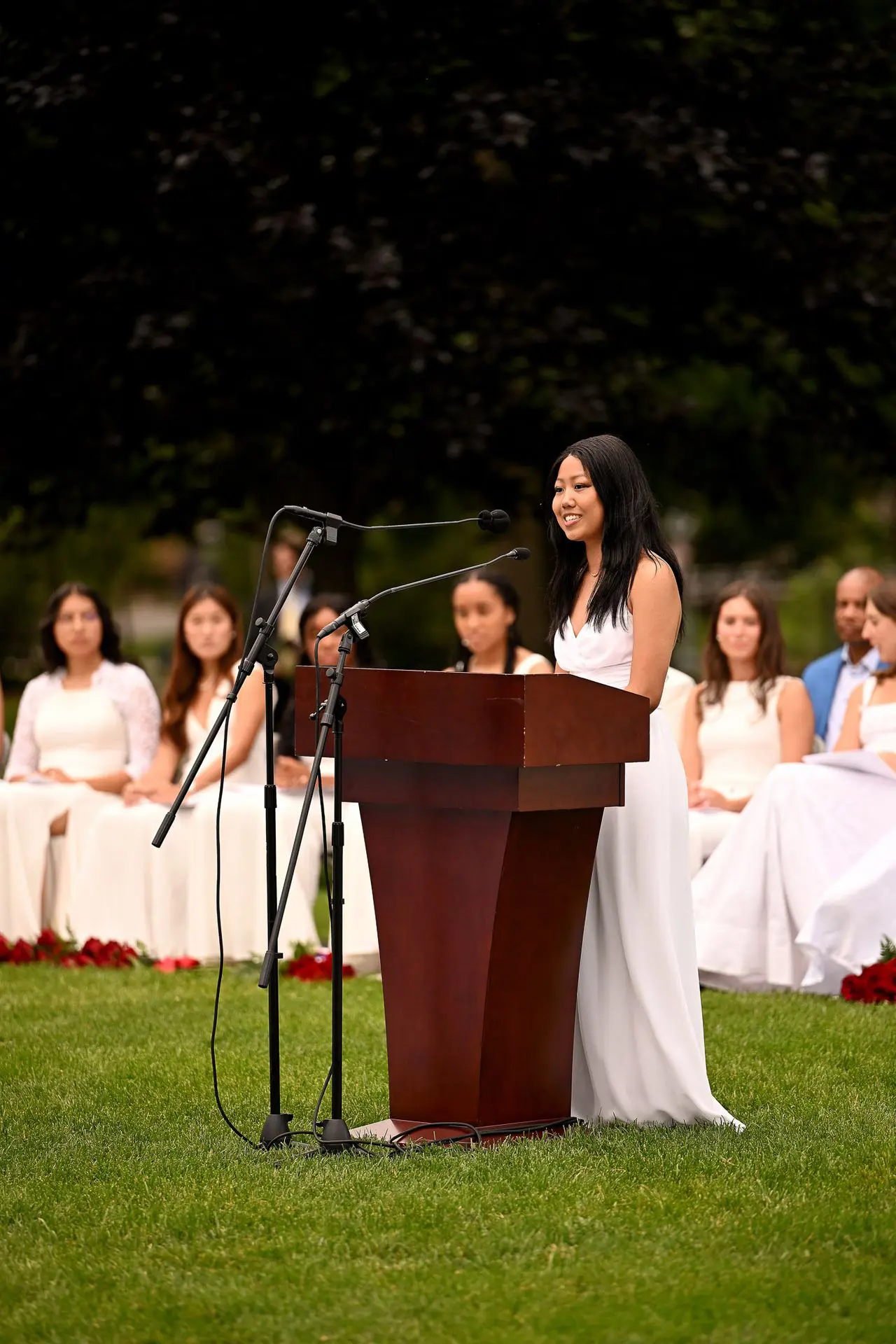 NCS girl in white dress giving speech